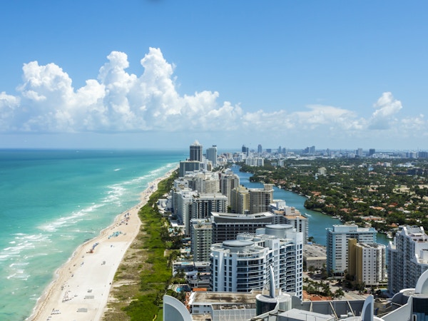 South Beach i Miami. Full utsikt over stranden til venstre og byen til høyre. Vakker blå himmel på en klar dag.